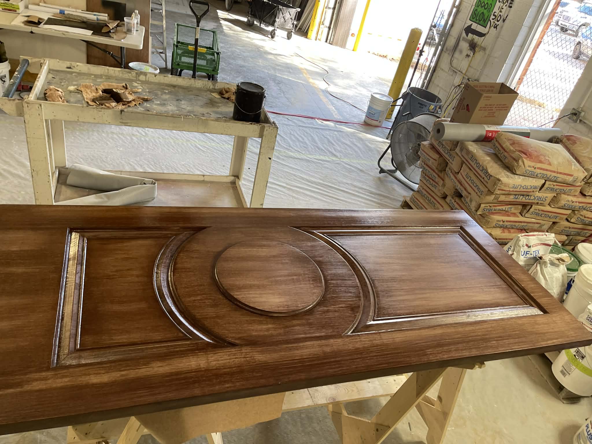 Custom faux wood grain finish on a decorative interior door by Carlson Painting Co.