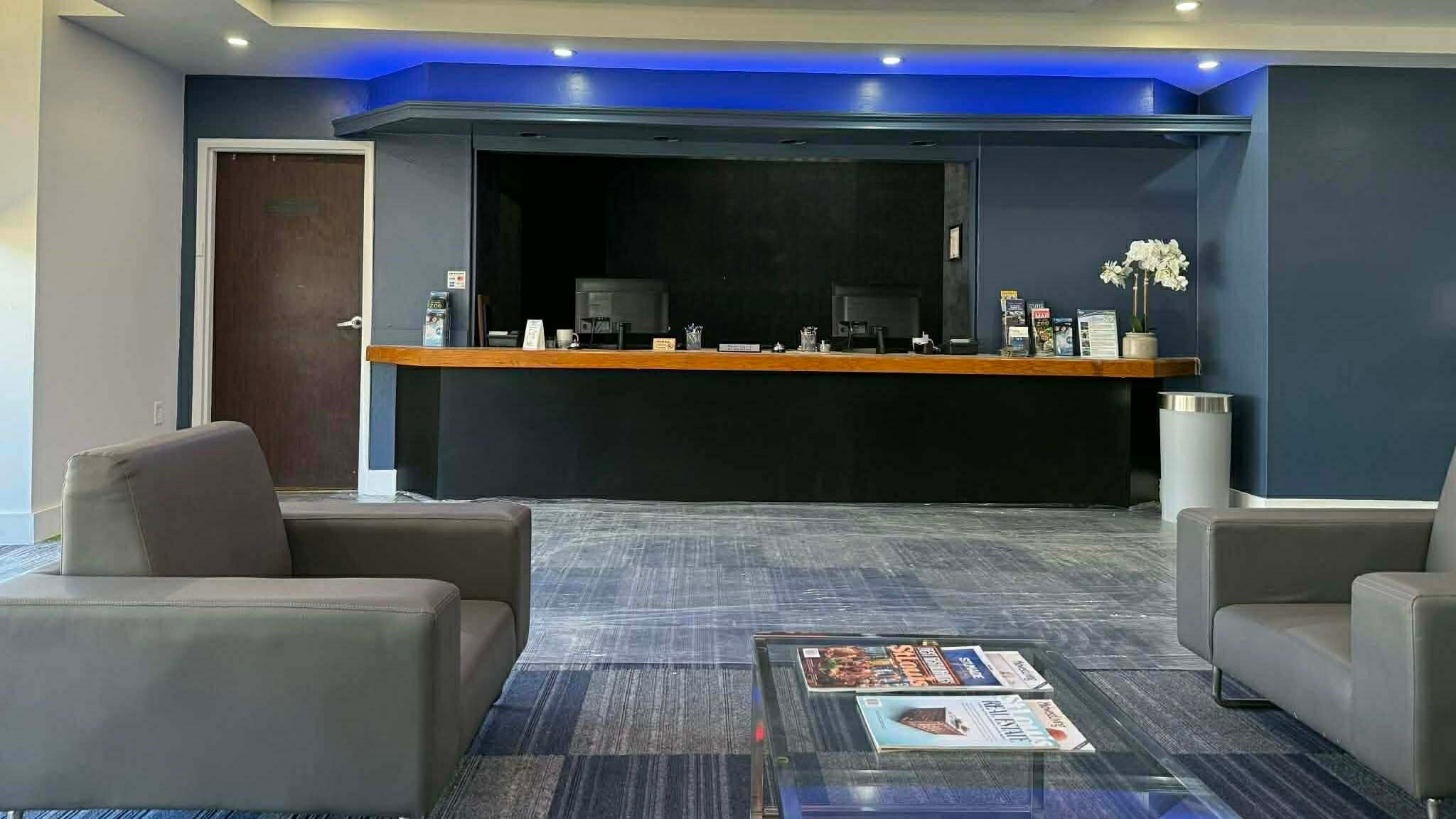 Commercial lobby and reception area painting by Carlson Painting Co. featuring a modern deep blue accent wall, clean white trim, and professional satin finishes. Commercial lobby and reception area painting by Carlson Painting Co. featuring a modern deep blue accent wall, clean white trim, and professional satin finishes.