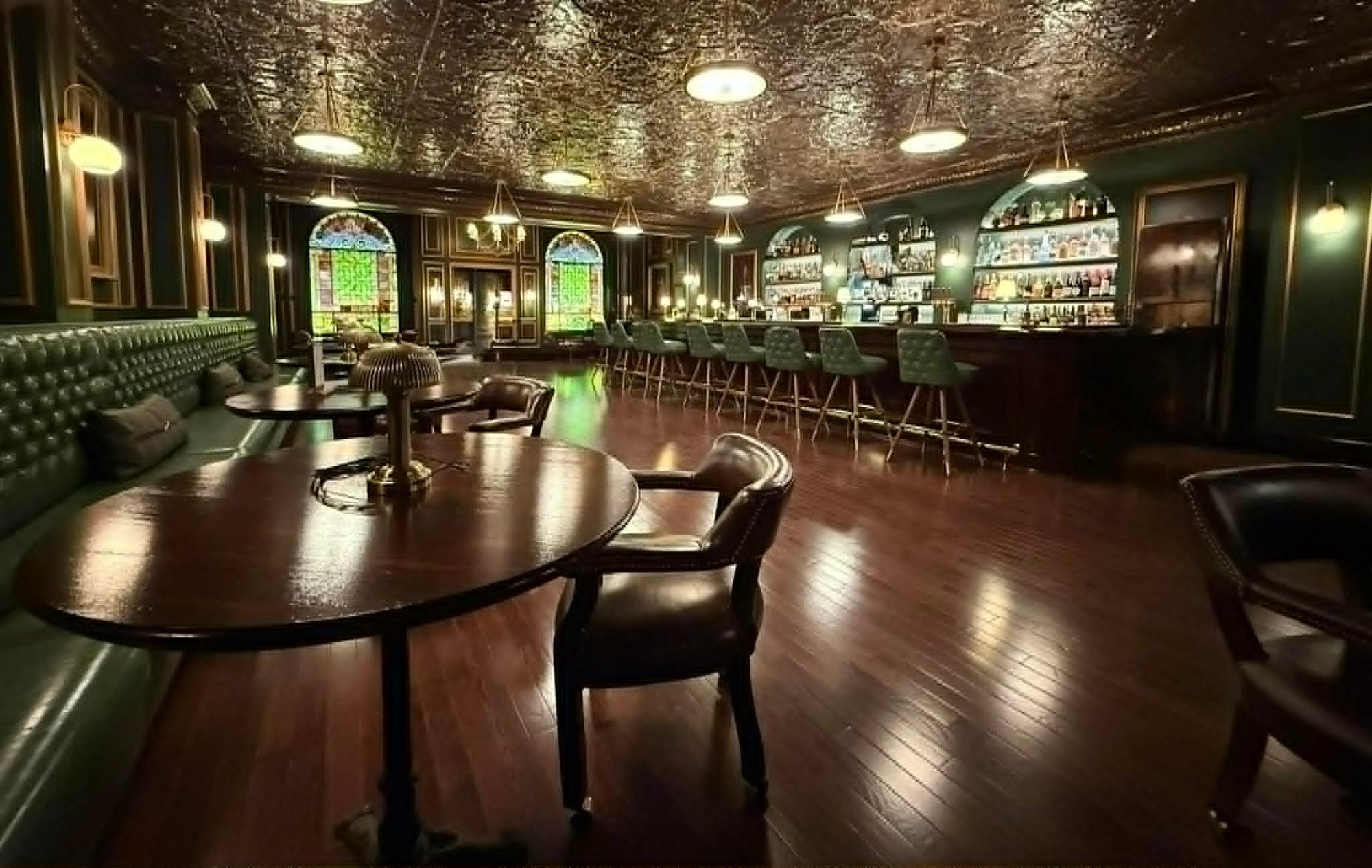Luxury commercial interior painting by Carlson Painting Co. featuring deep green matte walls, gold trim accents, and a metallic coffered ceiling in a high-end bar and lounge. Luxury commercial interior painting by Carlson Painting Co. featuring deep green matte walls, gold trim accents, and a metallic coffered ceiling in a high-end bar and lounge.