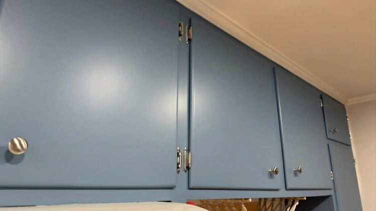 Boutique cabinet refinishing featuring a factory-smooth satin blue finish and precision-installed silver hardware by Carlson Painting Co. in Atlanta. Boutique cabinet refinishing featuring a factory-smooth satin blue finish and precision-installed silver hardware by Carlson Painting Co. in Atlanta.