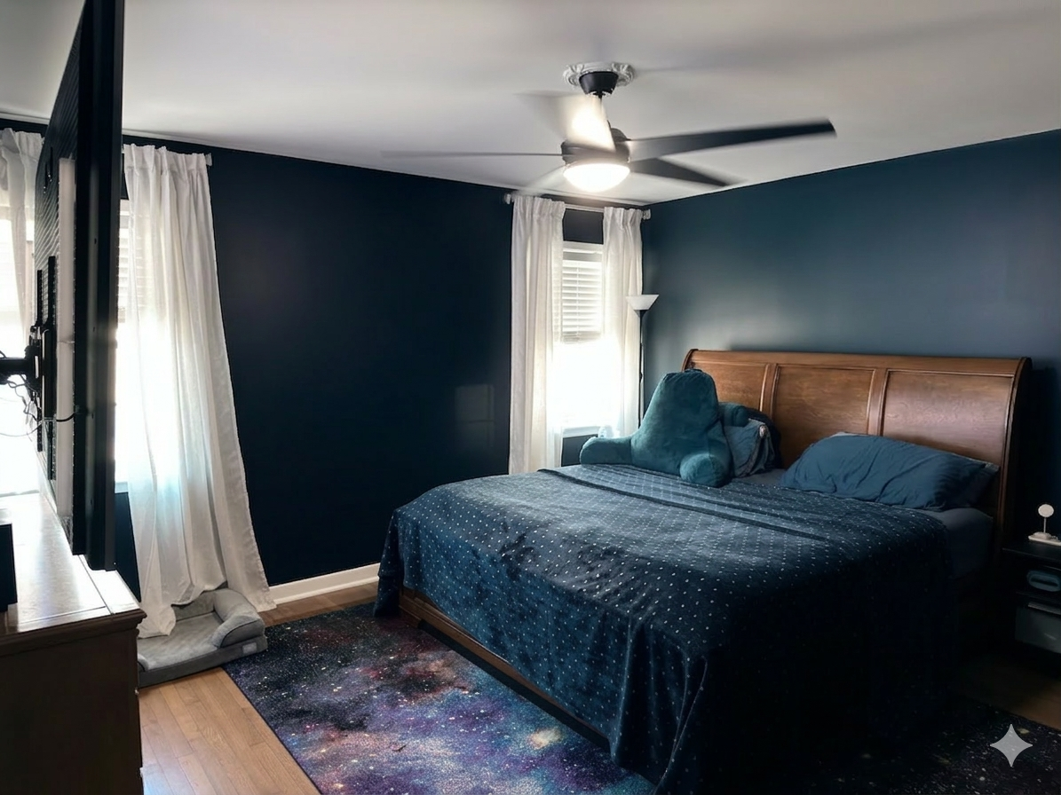 Professional interior accent wall painting in deep navy matte finish, executed by Carlson Painting Co. in a residential bedroom featuring crisp white trim and ceiling details.