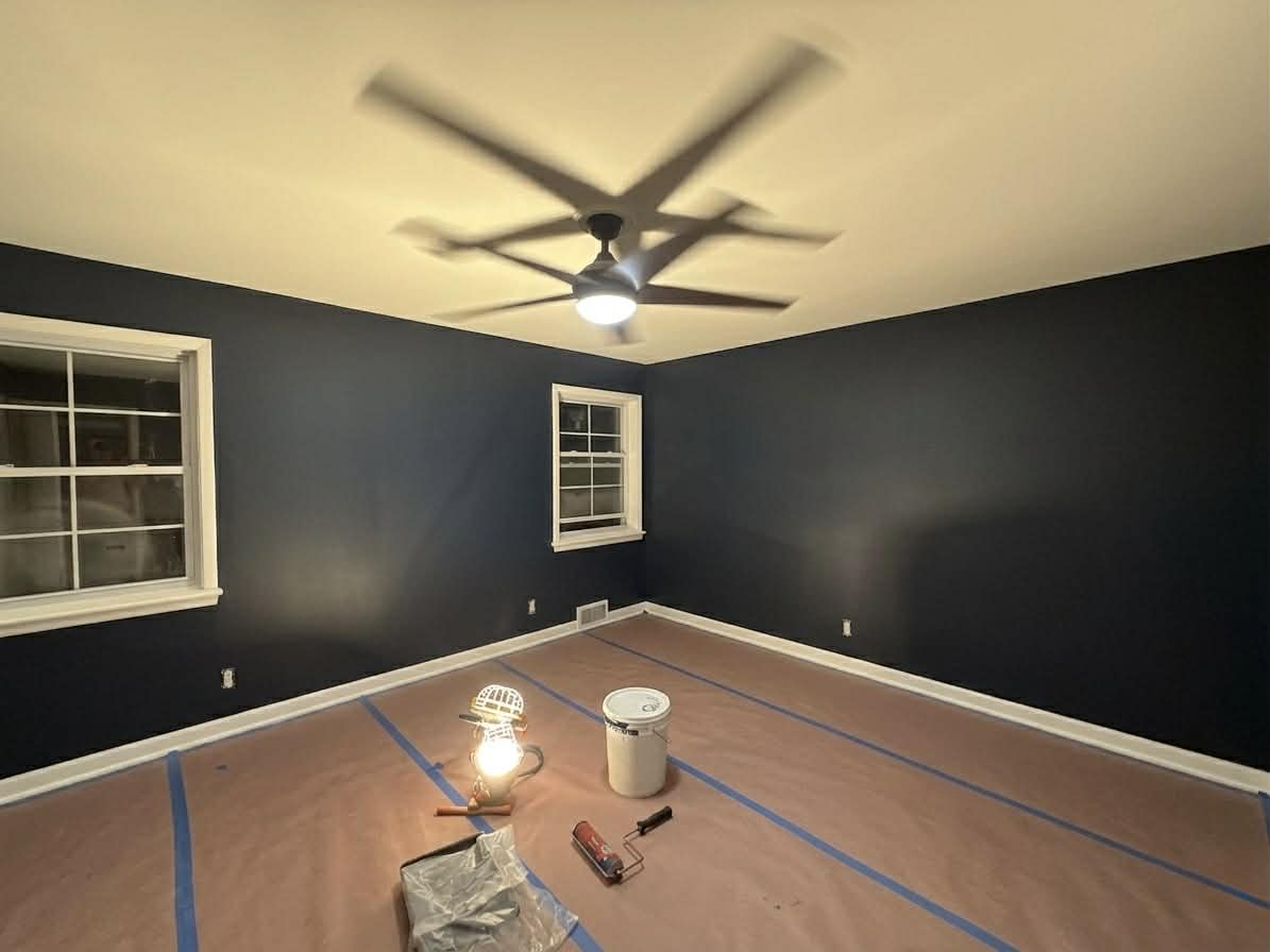 Residential interior painting in progress by Carlson Painting Co. featuring professional floor protection and precision blue wall finishes. Residential interior painting in progress by Carlson Painting Co. featuring professional floor protection and precision blue wall finishes.
